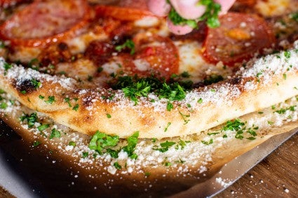 Close up of garlic butter, Parmesan, and herb pizza crust