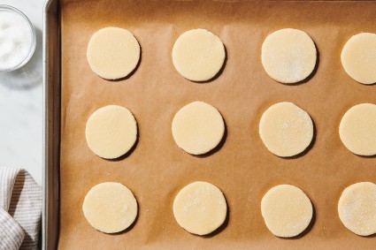 Circles of cookie dough on parchment-lined baking sheet