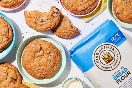 Chocolate chip cookies next to bag of bread flour