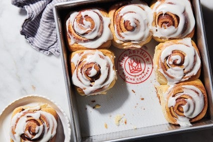 Square pan full of cinnamon rolls, lined with reusable silicone liner