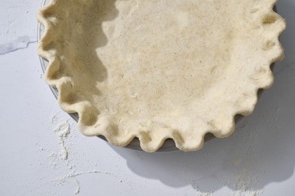 Overhead shot of raw pie crust in a pan. 