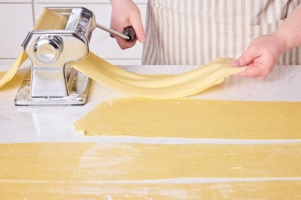 Rolling out egg noodles in a pasta machine