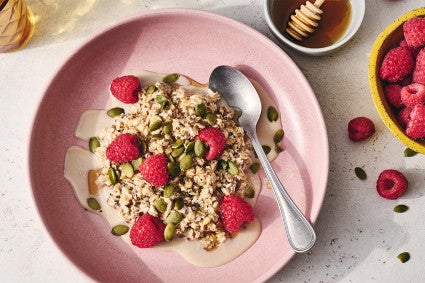 Simple Overnight Oats on a plate with raspberries and honey
