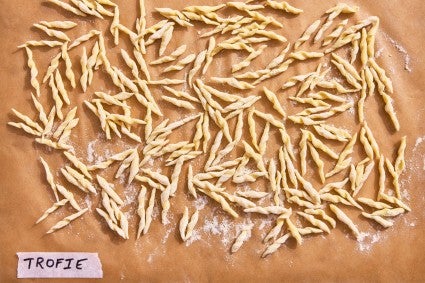 The shape of trophy pasta on a parchment line baking sheet