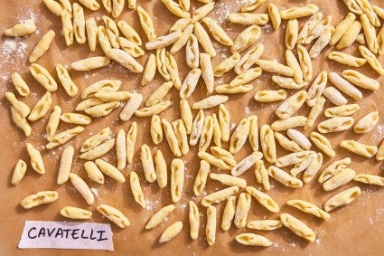Cavatelli pasta shape on a parchment line baking sheet