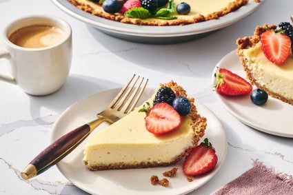Easy Cheesecake sliced and on a plate with a cup of coffee