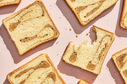 Slices of Swirled Maple Milk Bread; one with a bite taken out of it