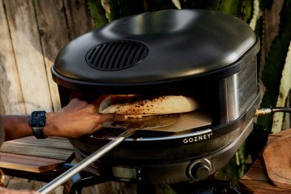 Baking a pizza in a gansney pizza oven