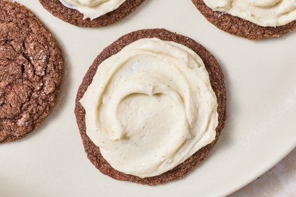 Top-down photograph of a soft chocolate sugar cookie that's been frosted.