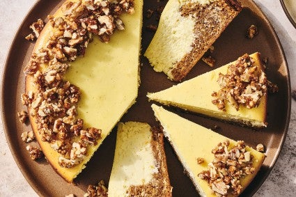 Carrot Cake Cheesecake with golden creamy cheesecake and edged with walnuts.