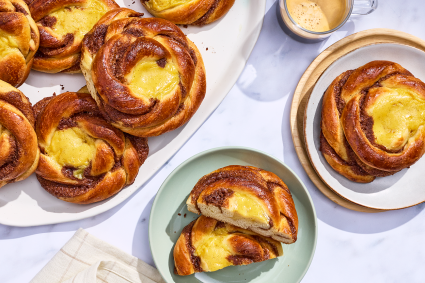 Sunshine buns on plates and arranged on a counter, seen from above.