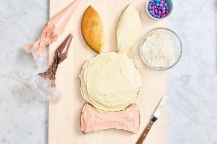 Partially decorated Easter bunny cake
