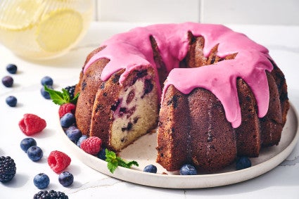 Berry Bliss Bundt Cake seen from the side with berries around the edges