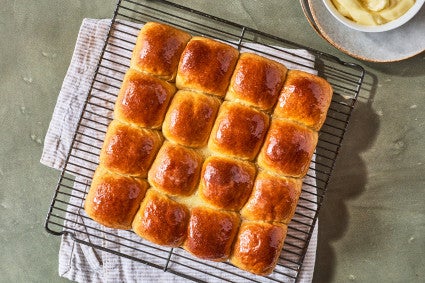 Whole Wheat Dinner Rolls on a cooling rack