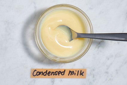 Bowl of condensed milk with a spoon in it