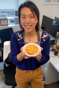 Justine Lee holding up a pastry 