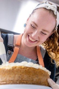 Emma Hayes frosting a cake