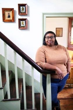 Debra Freeman standing at the foot of a home staircase