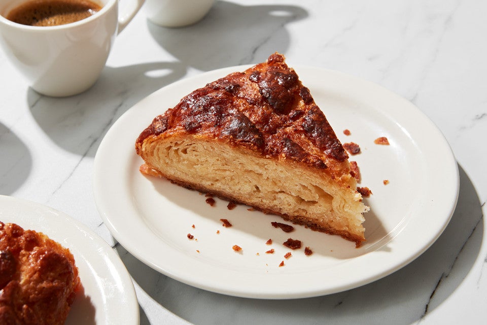 A plate with a slice of kouign-amann served