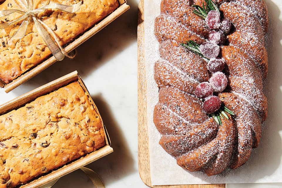 Sour Cream Fruitcake on cutting board and in bakeable paper pans