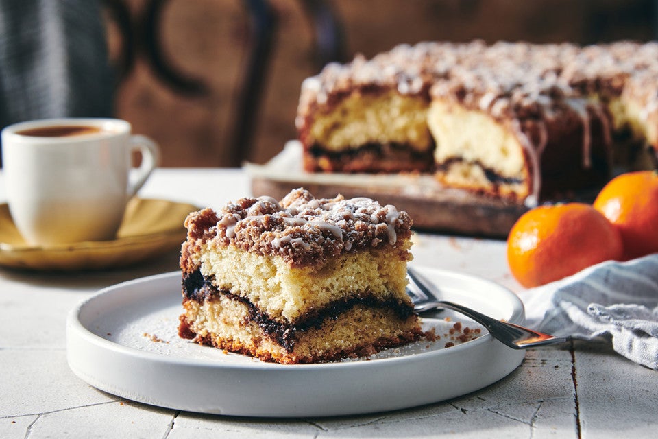 Slice of Cinnamon-Crisp Coffee Cake on a plate with coffee