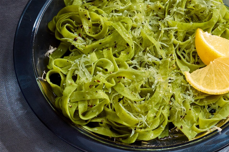 Fresh Herb Pasta on a plate with lemon slices