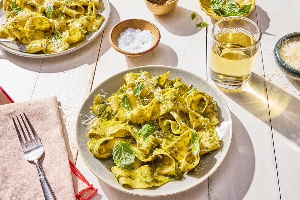 Fresh Pasta on a plate with a glass of wine