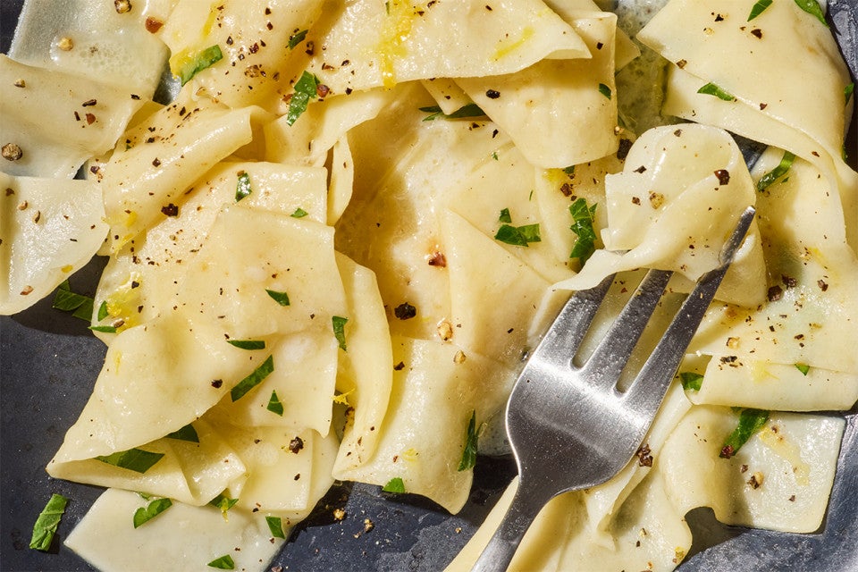 Homemade Egg Noodles up-close on a plate with a fork
