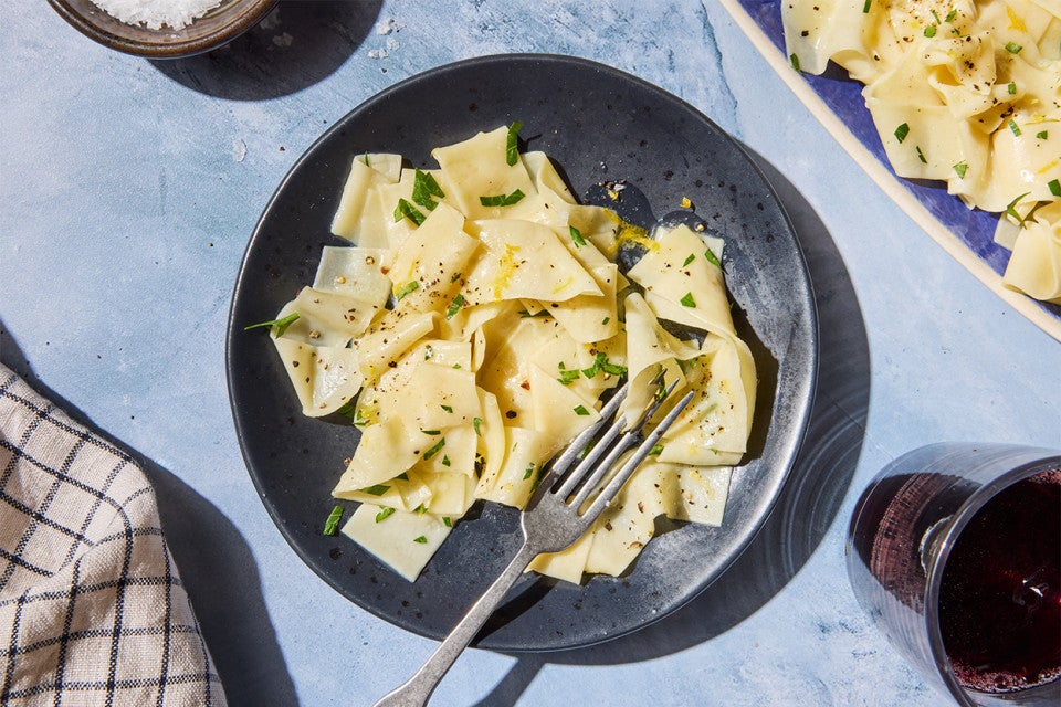 Homemade Egg Noodles on a plate served with red wine
