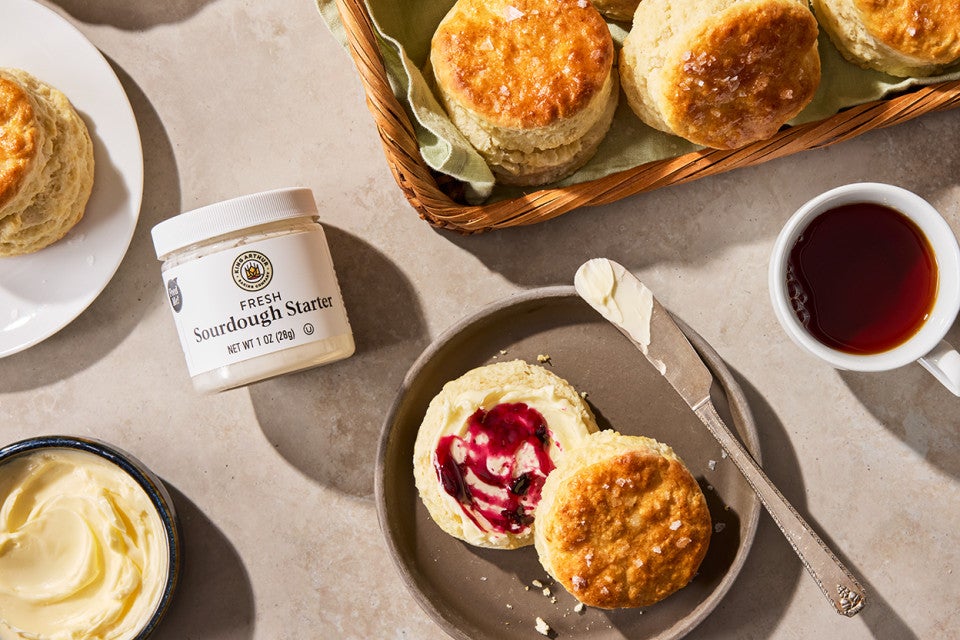 Sourdough Discard Buttermilk Biscuits on a plate with a cup of coffee