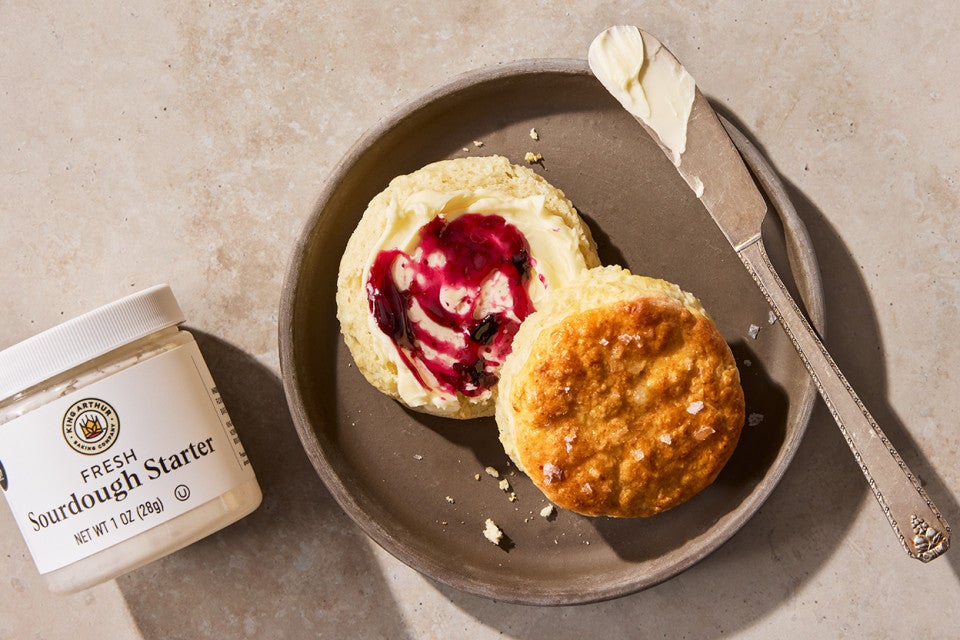 Sourdough Discard Buttermilk Biscuits on a plate with jam and butter