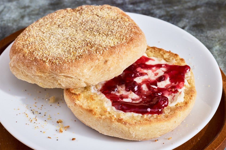Gluten-Free Sourdough English Muffins made with Bread Flour sliced on a plate with butter and jam