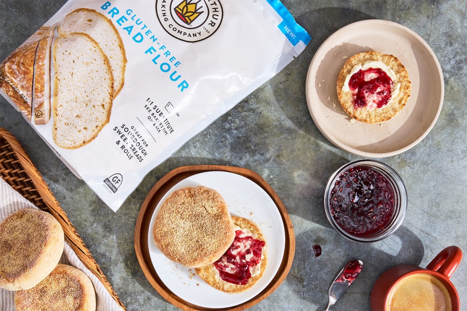 Gluten-Free Sourdough English Muffins made with Bread Flour sliced on a plate with butter and jam