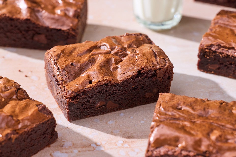 Small-Batch Brownies on a table with a glass of milk