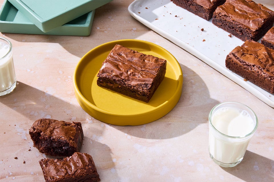A Small-Batch Brownie on a plate with milk