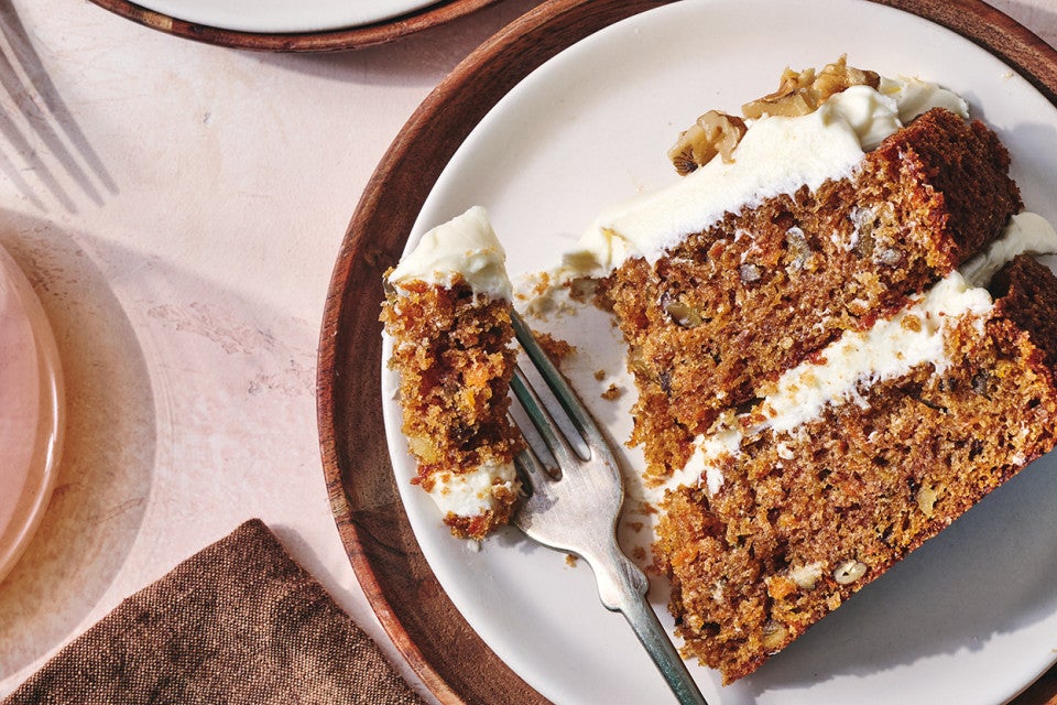 King Arthur's Carrot Cake sliced on a plate with a fork taken out of it