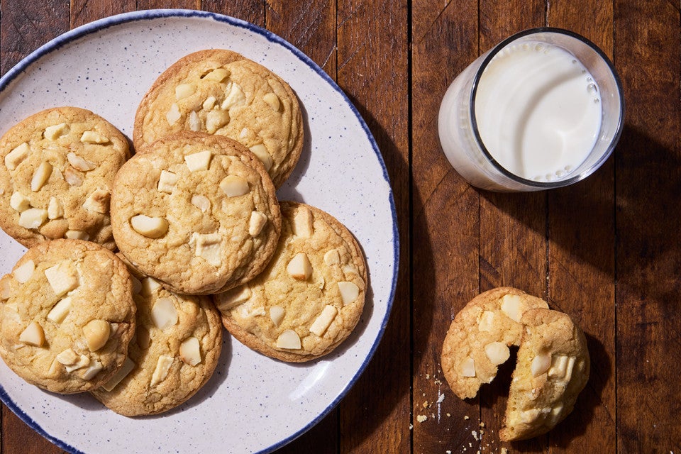 White Chocolate Macadamia Nut Cookies on a plate with a glass of milk