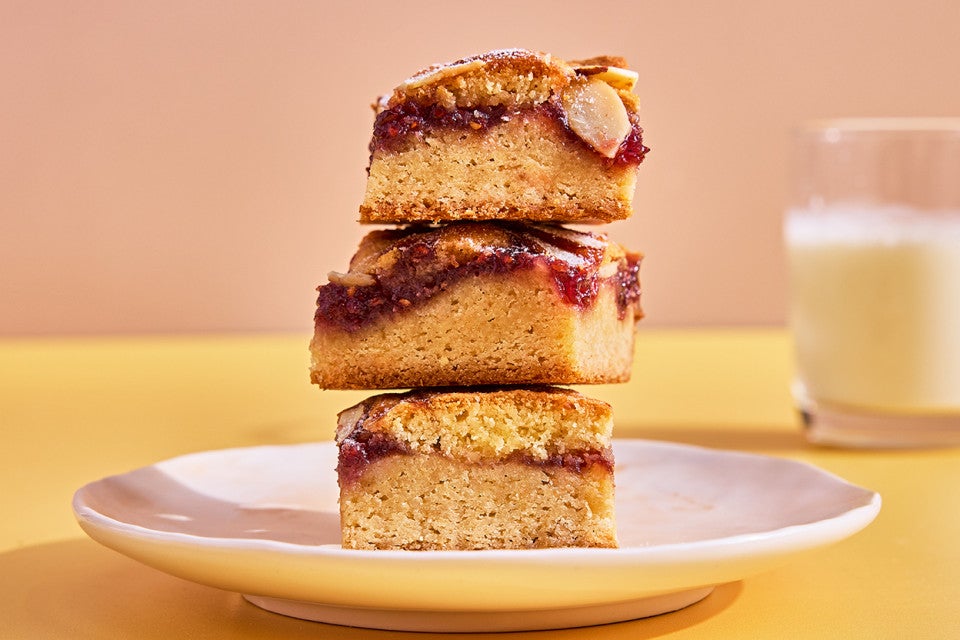 Raspberry Frangipane Bars stacked up on a plate