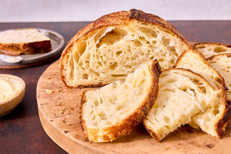 Croissant Sourdough Bread sliced and on a cutting board