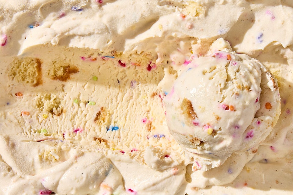 Birthday Cake Ice Cream in a container with a scoop