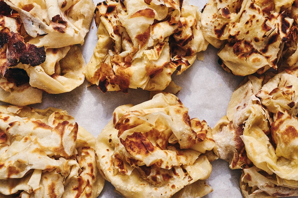Buss Up Shut (Paratha Roti) on a sheet of parchment