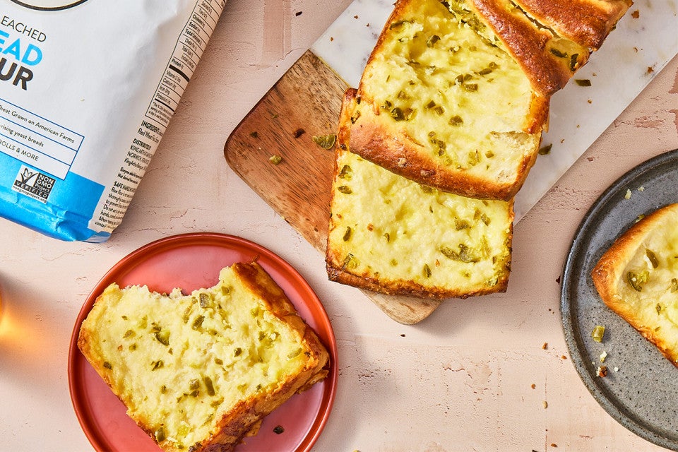 Jalapeño-Cheddar Pull-Apart Bread on a cutting board and served on a plate