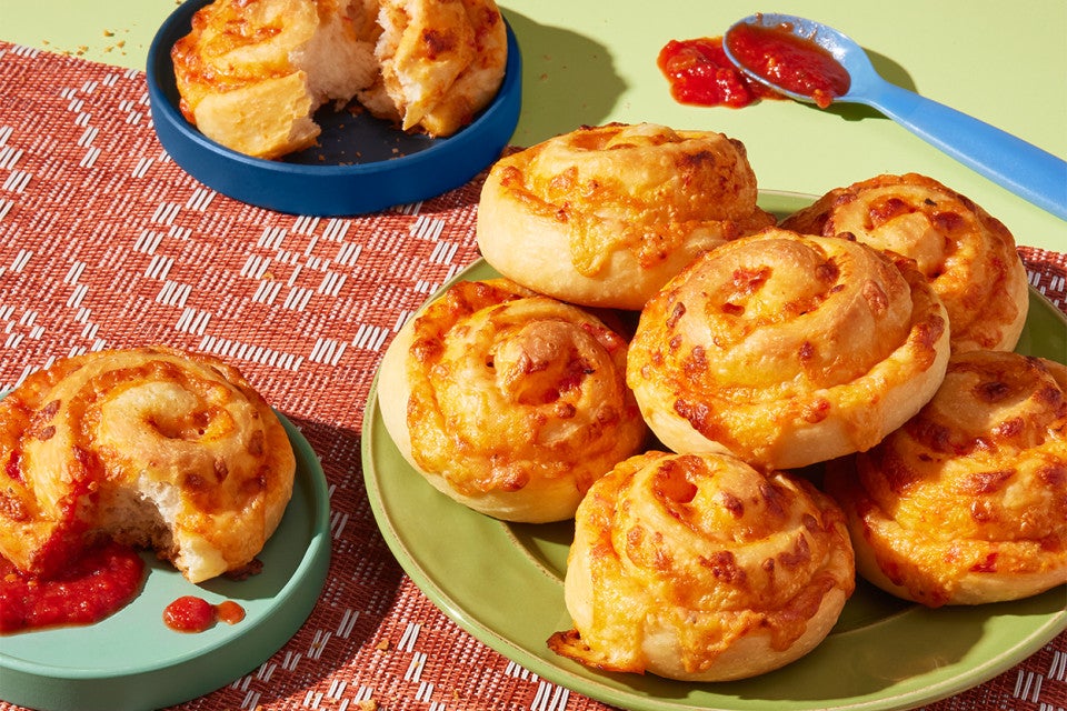 Pizza Party Buns served on plates with some tomato sauce