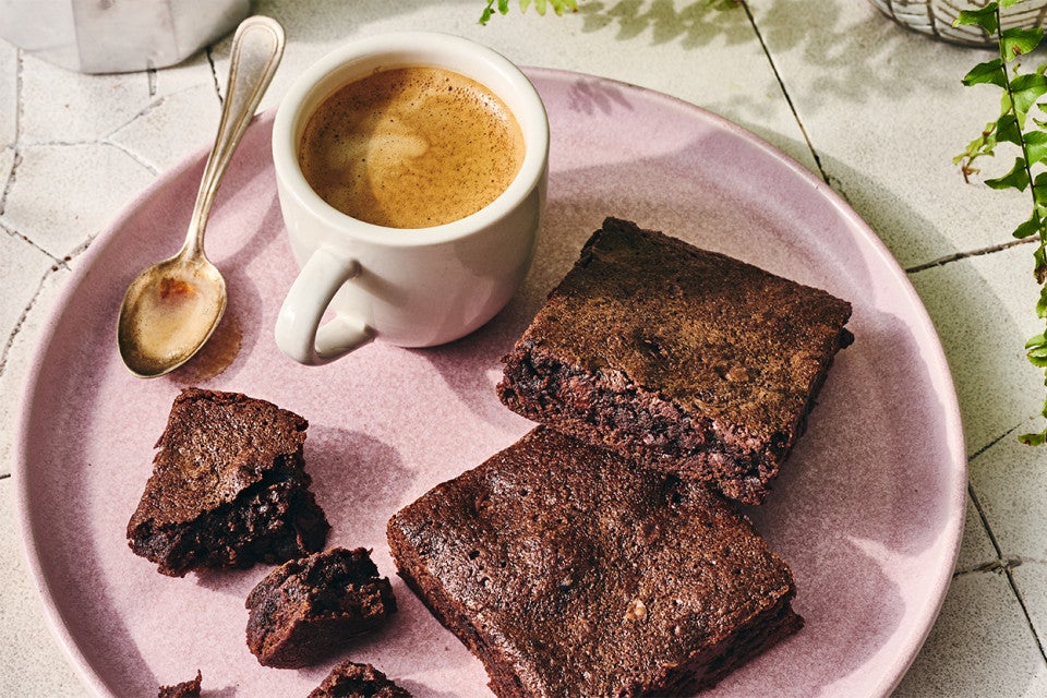 Quick and Easy Brownies on a plate with a cup of coffee