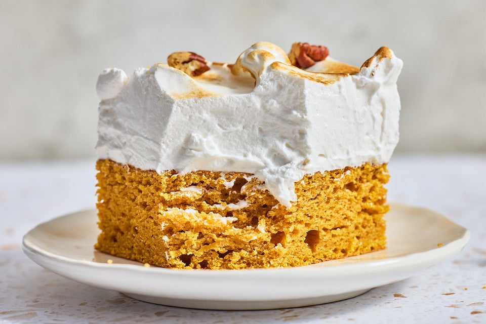 A slice of Sweet Potato Cake with Marshmallow Frosting on a plate