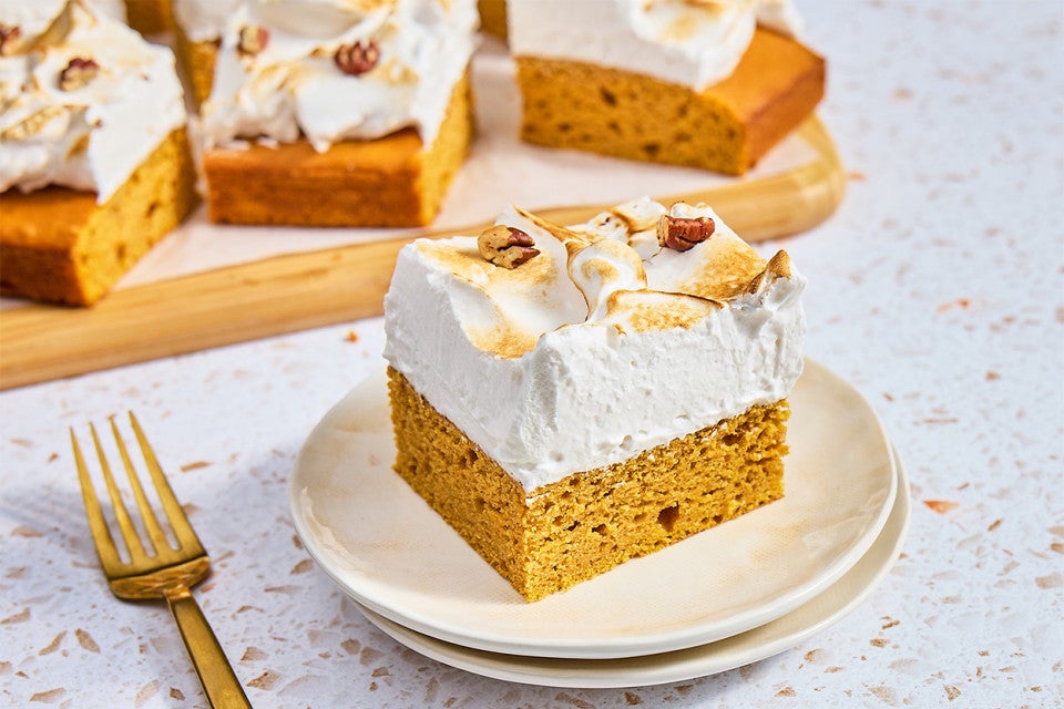 A slice of Sweet Potato Sheet Cake with Marshmallow Frosting on a plate