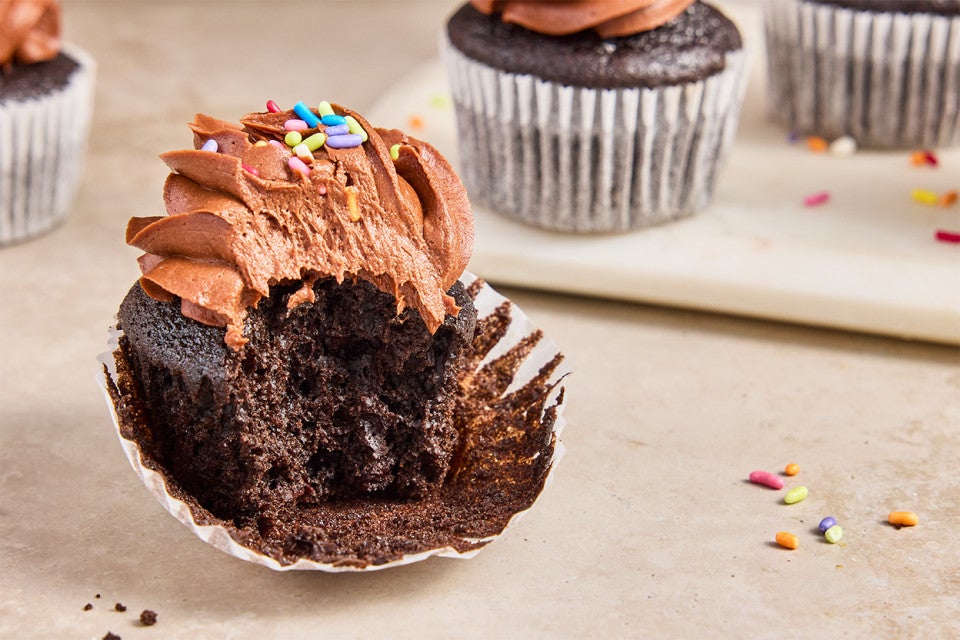 A Bake Sale Fudge Cupcake with a bite taken out of it