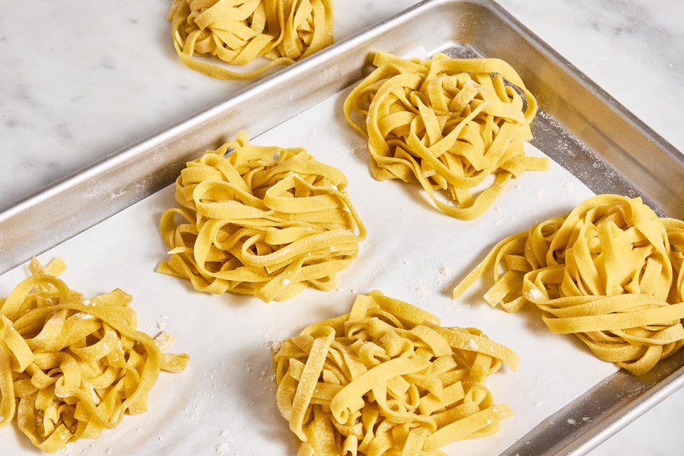 Homemade Pasta in nests on a sheet pan