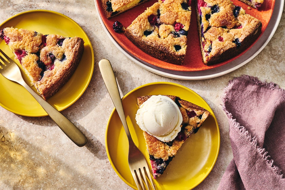 Slices of Late Summer Berry Torte on plates with a scoop of vanilla ice cream