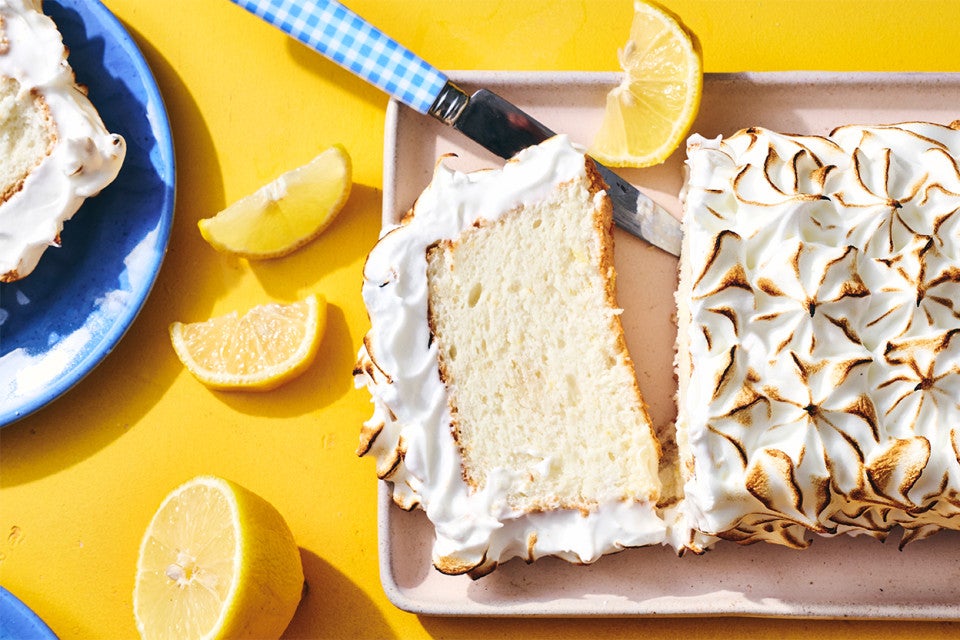 Lemon Angel Food Cake with Meringue Topping sliced on a serving tray